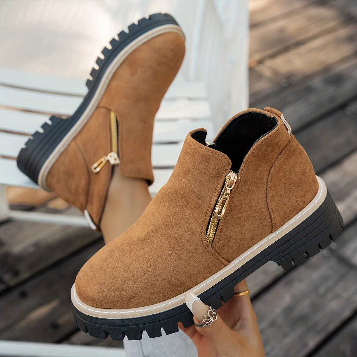 Tan ELARA ankle boots held to show side zips