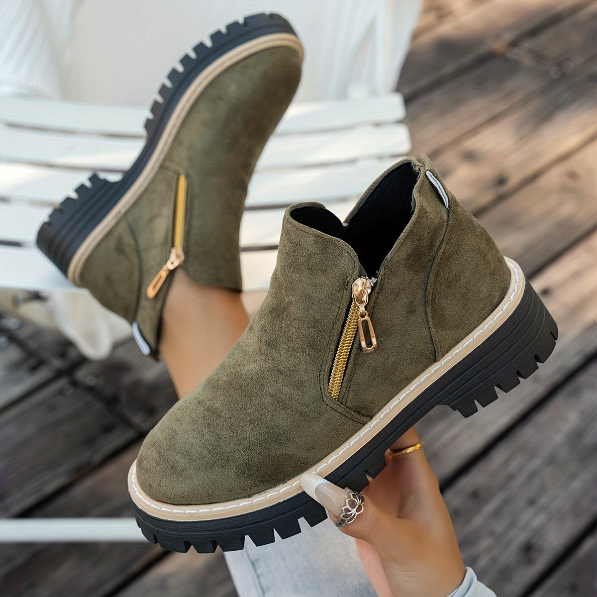 Green ELARA ankle boots held to show chunky soles