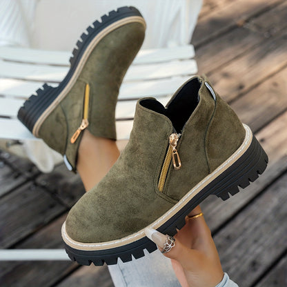 Green ELARA ankle boots held to show chunky soles